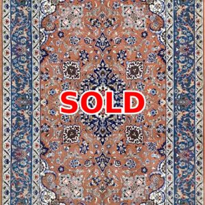 Persian-style rug with an orange field and blue floral border, marked SOLD.