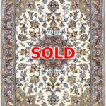 Cream-colored oriental rug with blue, red, and gold floral pattern; large red SOLD text over the center indicating sold status