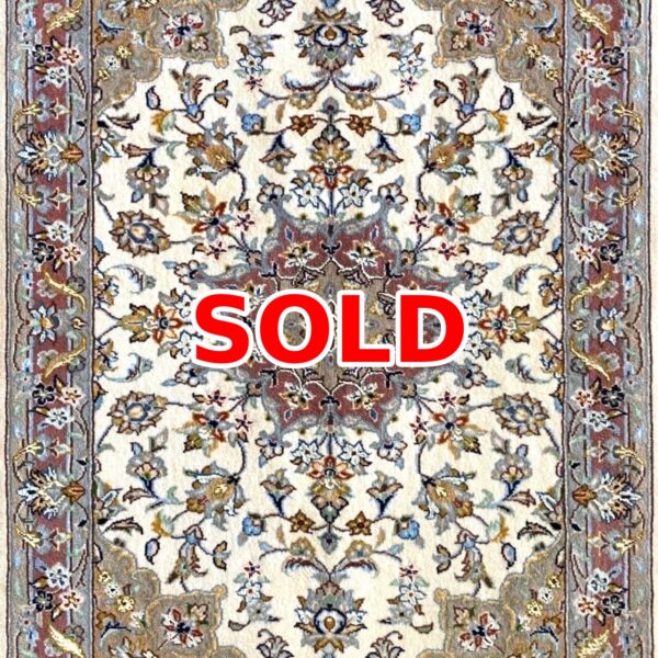 Cream-colored oriental rug with blue, red, and gold floral pattern; large red SOLD text over the center indicating sold status